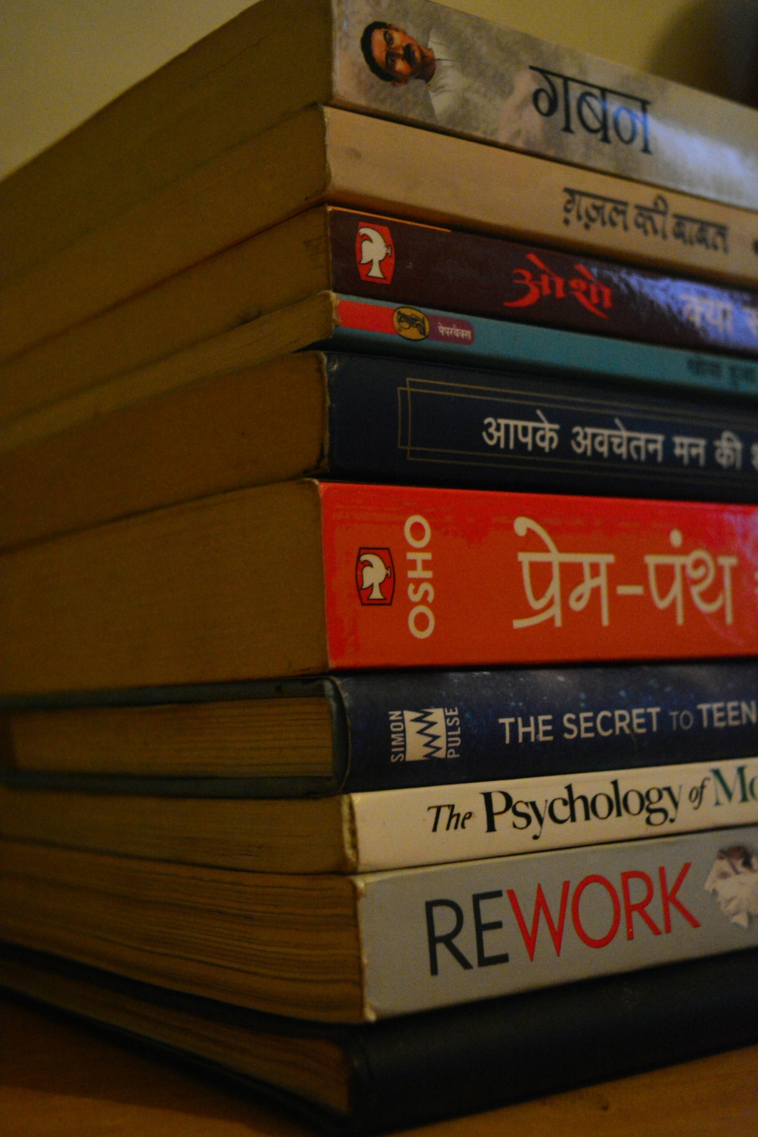 a stack of books sitting on top of a wooden table