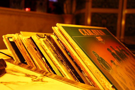 A stack of vinyl records on a table.